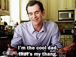 A Man In A Blue Shirt Is Sitting In A Kitchen And Says I 'M The Cool Dad That 'S My Thang GIF