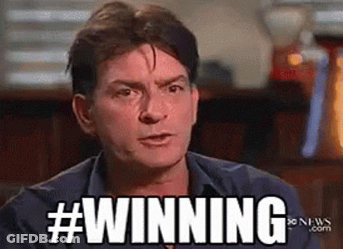 Man In Blue Shirt In Front Of #Winning Sign GIF