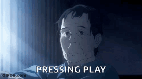 A Man In A Blue Shirt Is Sitting In Front Of A Window . GIF