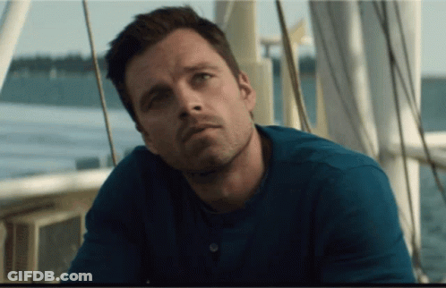 A Man In A Blue Shirt Is Sitting On A Boat Near The Water GIF