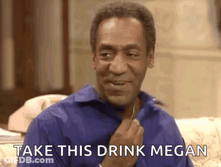 A Man In A Blue Shirt Is Sitting On A Couch With The Words `` Take This Drink Megan '' Written On It . GIF