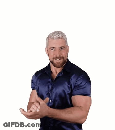 A Man In A Blue Shirt Is Smiling And Making A Funny Face GIF
