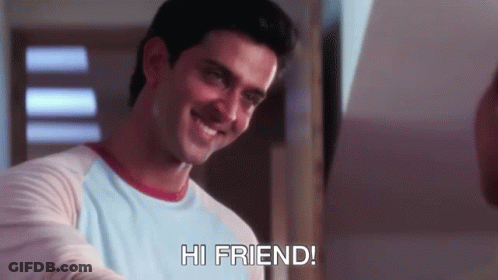 A Man In A Blue Shirt Is Smiling And Says Hi Friend GIF