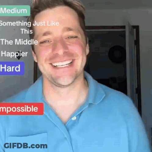 A Man In A Blue Shirt Is Smiling In Front Of A Sign That Says Something Just Like This GIF