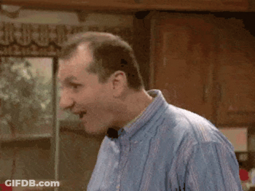 Man In Blue Shirt With Mouth Open In Kitchen GIF