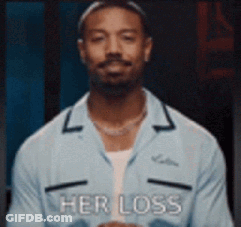 A Man In A Blue Shirt Is Standing In Front Of A Black Background And Says `` Her Loss '' . GIF