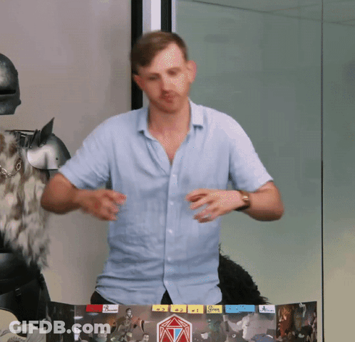 A Man In A Blue Shirt Is Standing In Front Of A Board With A Sticker That Says ' A ' On It GIF