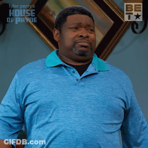 A Man In A Blue Shirt Is Standing In Front Of A Framed Picture That Says House Of Payne GIF