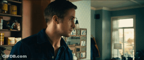 A Man In A Blue Shirt Is Standing In Front Of A Shelf With A Sign That Says ' A ' GIF