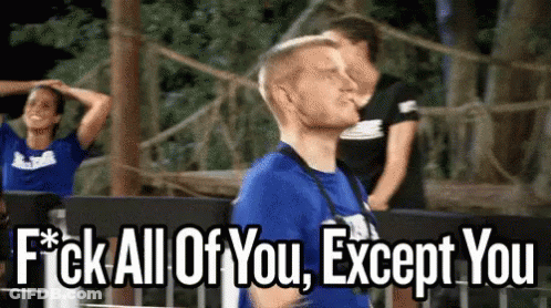 A Man In A Blue Shirt Is Standing In Front Of A Sign That Says " Fuck All Of You Except You " GIF