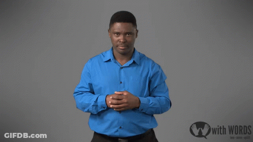 A Man In A Blue Shirt Is Standing In Front Of A Sign That Says " With Words " GIF
