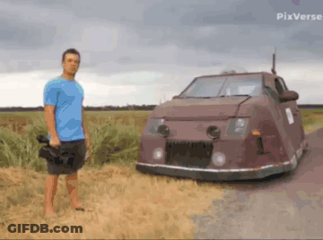 A Man In A Blue Shirt Is Standing Next To A Car With Pixverse Written In The Corner GIF