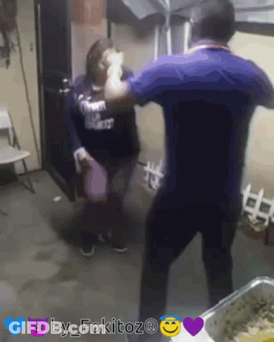 A Man In A Blue Shirt Is Standing Next To A Woman In A Black Shirt That Says ' I Love You ' On It GIF