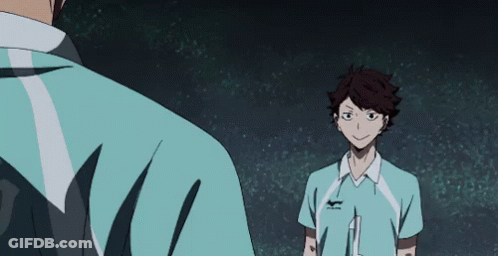 A Man In A Blue Shirt Is Standing Next To Another Man In A Blue Shirt . GIF