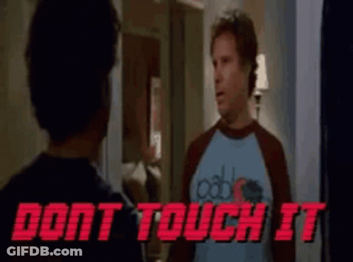 A Man In A Blue Shirt Is Standing Next To Another Man In A Red Shirt . GIF
