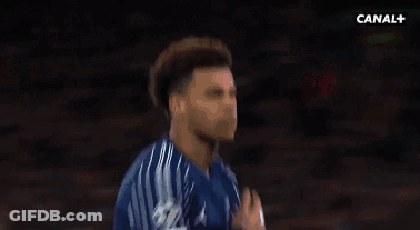 A Man In A Blue Shirt Is Standing Next To Another Man . GIF