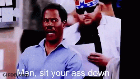 A Man In A Blue Shirt Is Standing Next To Another Man With The Words Man Sit Your Ass Down GIF