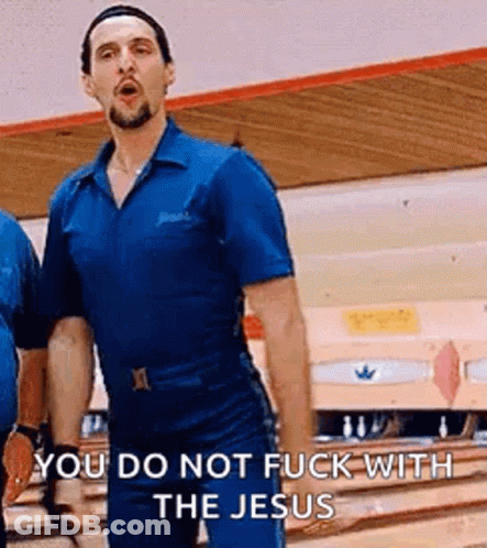 A Man In A Blue Shirt Is Standing On A Bowling Alley . GIF