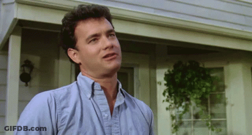 A Man In A Blue Shirt Is Standing On A Porch GIF