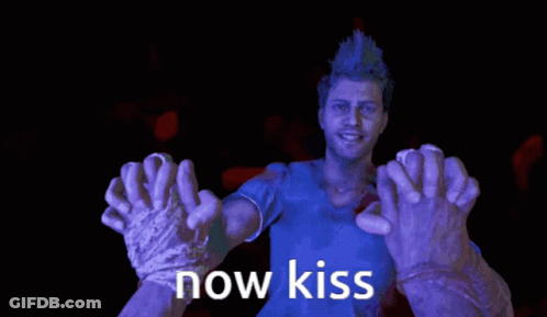 A Man In A Blue Shirt Is Surrounded By Purple Hands That Say " Now Kiss " GIF