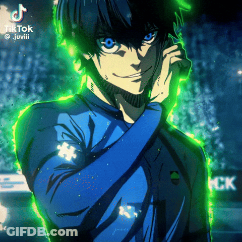 A Man In A Blue Shirt Is Talking On A Cell Phone With A Green Background GIF