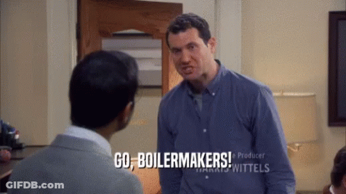A Man In A Blue Shirt Is Talking To Another Man And Says Go Boilermakers GIF