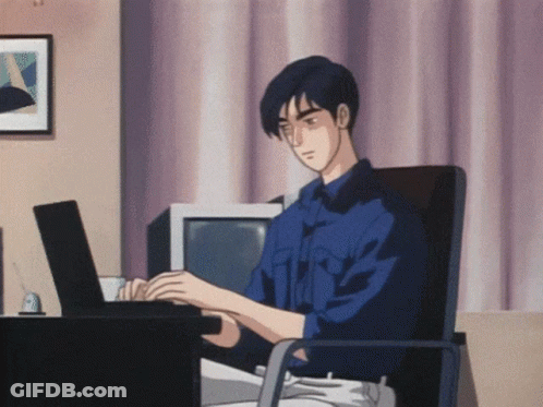 A Man In A Blue Shirt Is Typing On A Black Laptop GIF