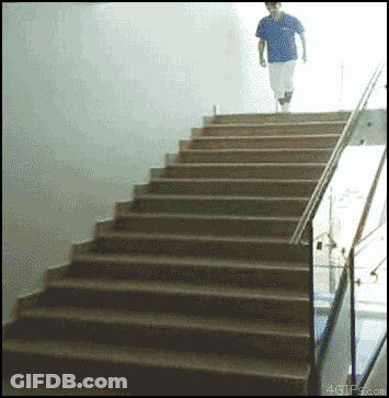 A Man In A Blue Shirt Is Walking Up A Set Of Stairs With 4Gifs.com In The Corner GIF