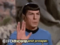 A Man In A Blue Shirt Is Waving His Hand And Says Live Long And Prosper GIF