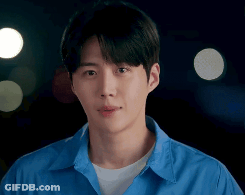 A Man In A Blue Shirt Looks At The Camera GIF