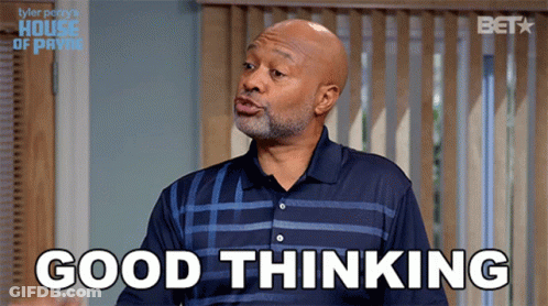 A Man In A Blue Shirt Says Good Thinking In Front Of A Window GIF