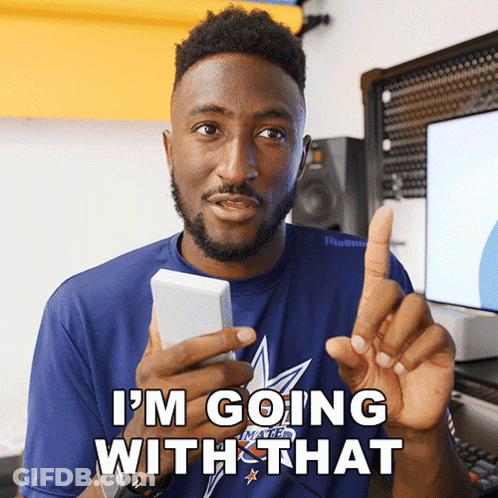 A Man In A Blue Shirt Says I 'M Going With That While Holding A Cell Phone GIF