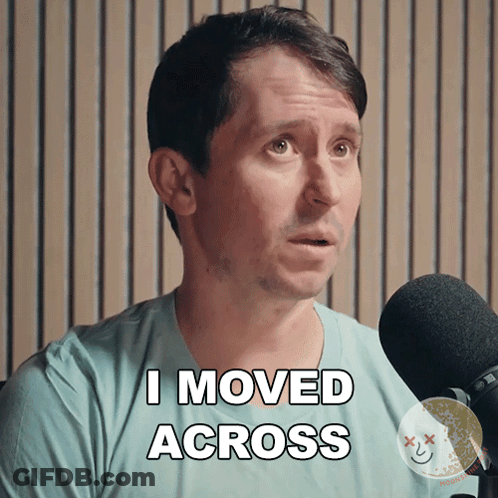 A Man In A Blue Shirt Says I Moved Across In Front Of A Microphone GIF