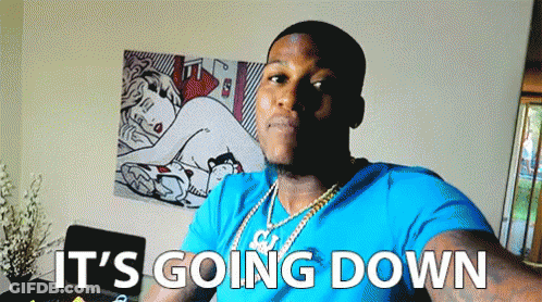 A Man In A Blue Shirt Says It 'S Going Down In Front Of A Painting GIF