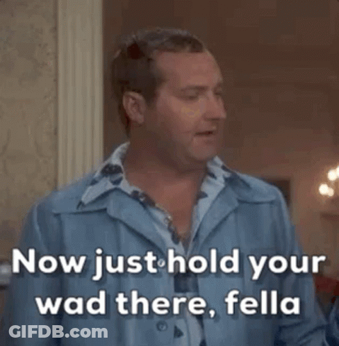 A Man In A Blue Shirt Says " Now Just Hold Your Wad There , Fella " GIF