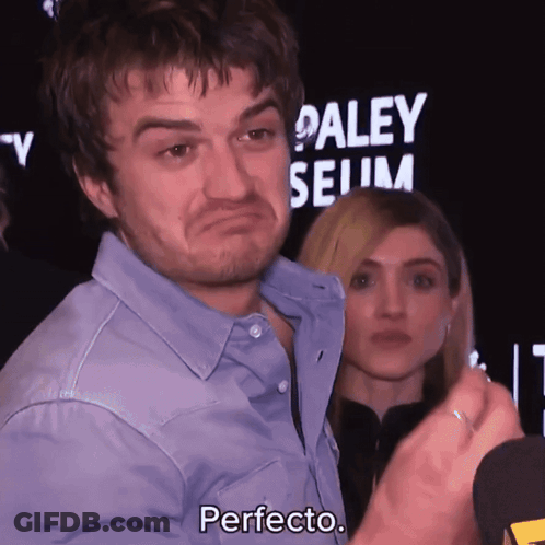 A Man In A Blue Shirt Says Perfecto In Front Of A Paley Museum Sign GIF