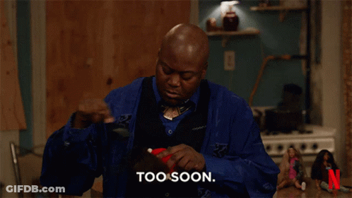 A Man In A Blue Shirt Says Too Soon In Front Of A Netflix Logo GIF
