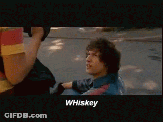 A Man In A Blue Shirt Says Whiskey In A Movie Scene GIF