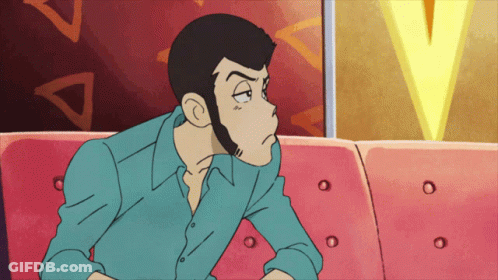 A Man In A Blue Shirt Sits On A Pink Couch GIF