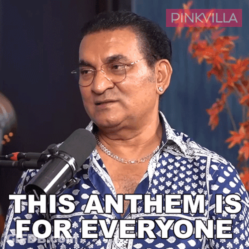 A Man In A Blue Shirt Stands In Front Of A Microphone And Says This Anthem Is For Everyone GIF