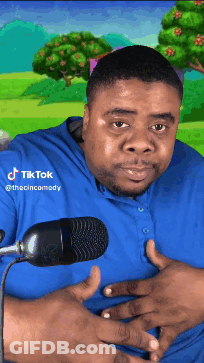 A Man In A Blue Shirt Stands In Front Of A Microphone With Tiktok Written On The Bottom Of His Shirt GIF