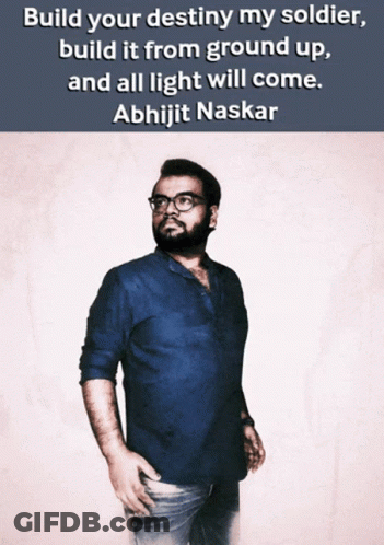 A Man In A Blue Shirt Stands In Front Of A Quote From Abhijit Naskar GIF
