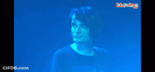 A Man In A Blue Shirt Stands In Front Of A Screen That Says Laplaza GIF