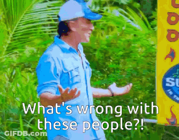 A Man In A Blue Shirt Stands In Front Of A Sign That Says What 'S Wrong With These People ? GIF