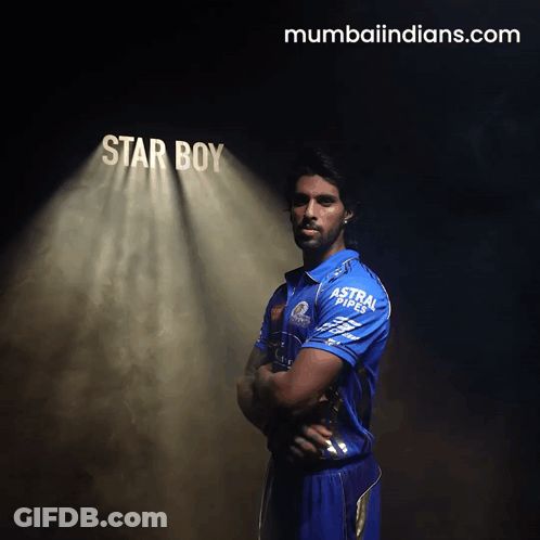 A Man In A Blue Shirt Stands In Front Of A Spotlight That Says Star Boy GIF