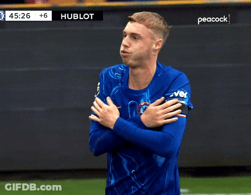 A Man In A Blue Shirt Stands On A Soccer Field With Peacock Written On The Bottom GIF