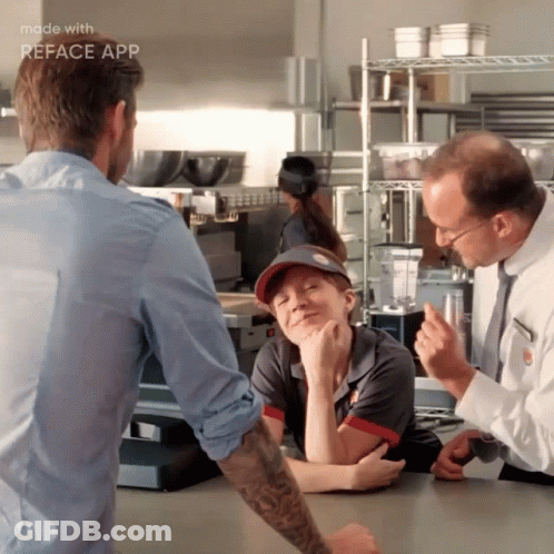 A Man In A Blue Shirt Talks To A Woman In A Mcdonalds Uniform GIF