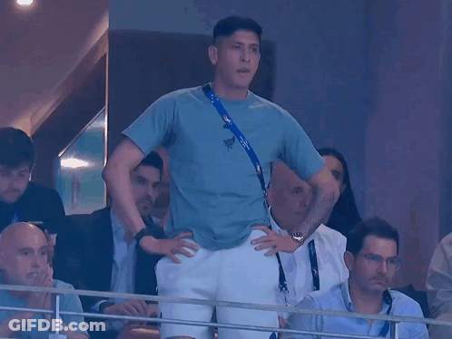 A Man In A Blue Shirt With A Lanyard Around His Neck That Says ' Russia ' On It GIF