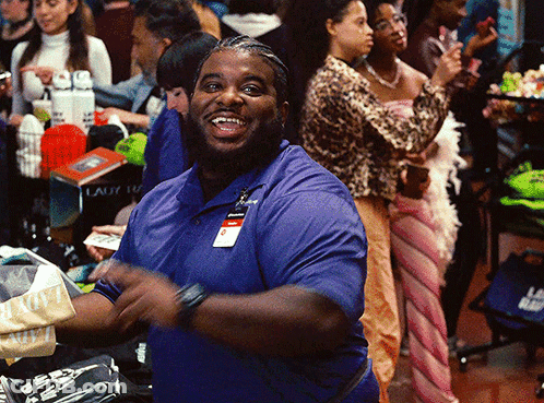 A Man In A Blue Shirt With A Name Tag That Says ' Smith ' On It Is Smiling GIF