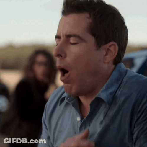 A Man In A Blue Shirt With His Mouth Open GIF